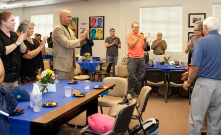 The UIL staff gives Bonnie Northcutt a standing ovation at her retirement party. 